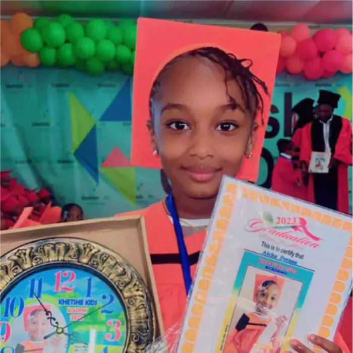 A proud 2023 graduate with her certificate